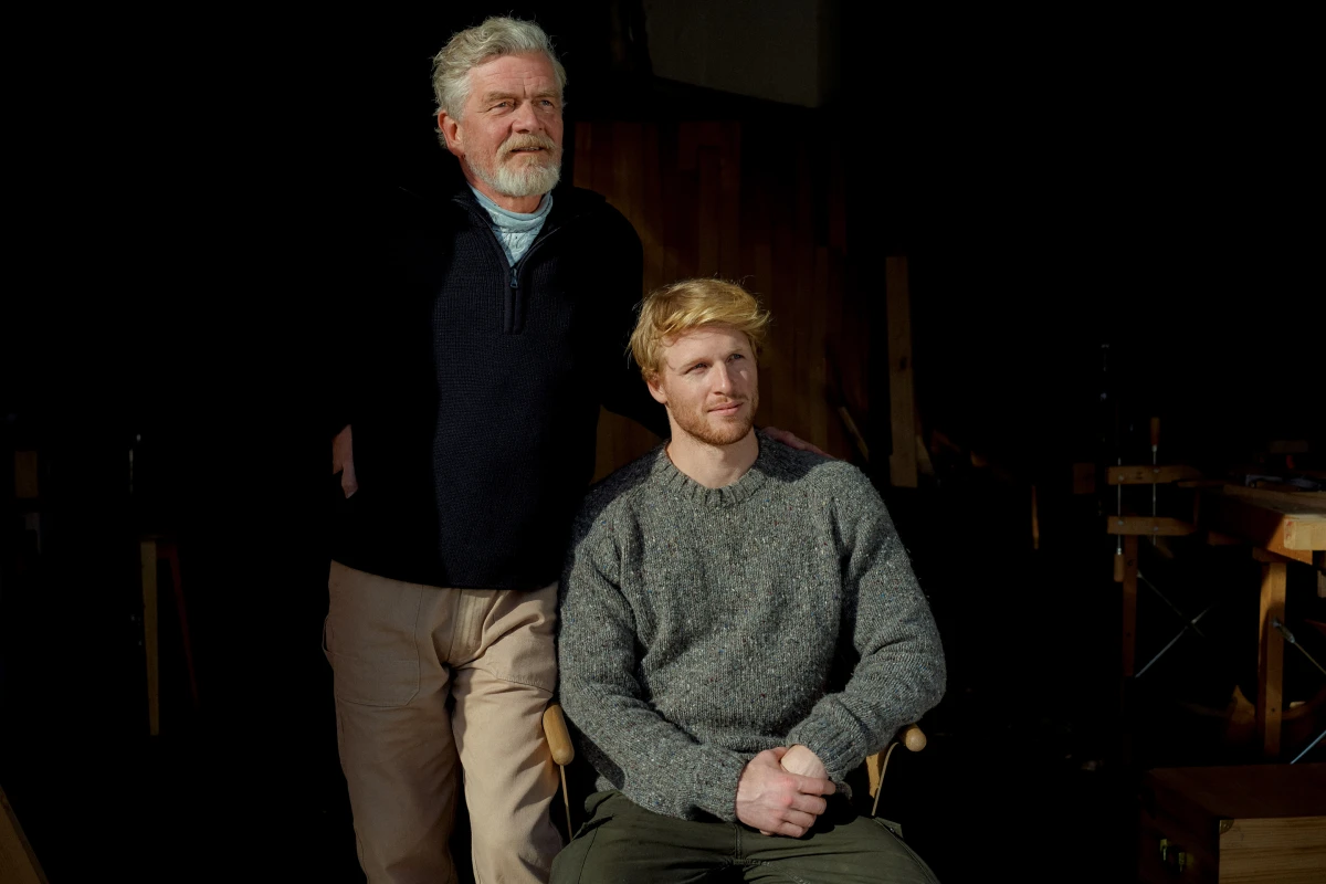 Older couple seated together in dark interior for DKB banking lifestyle campaign