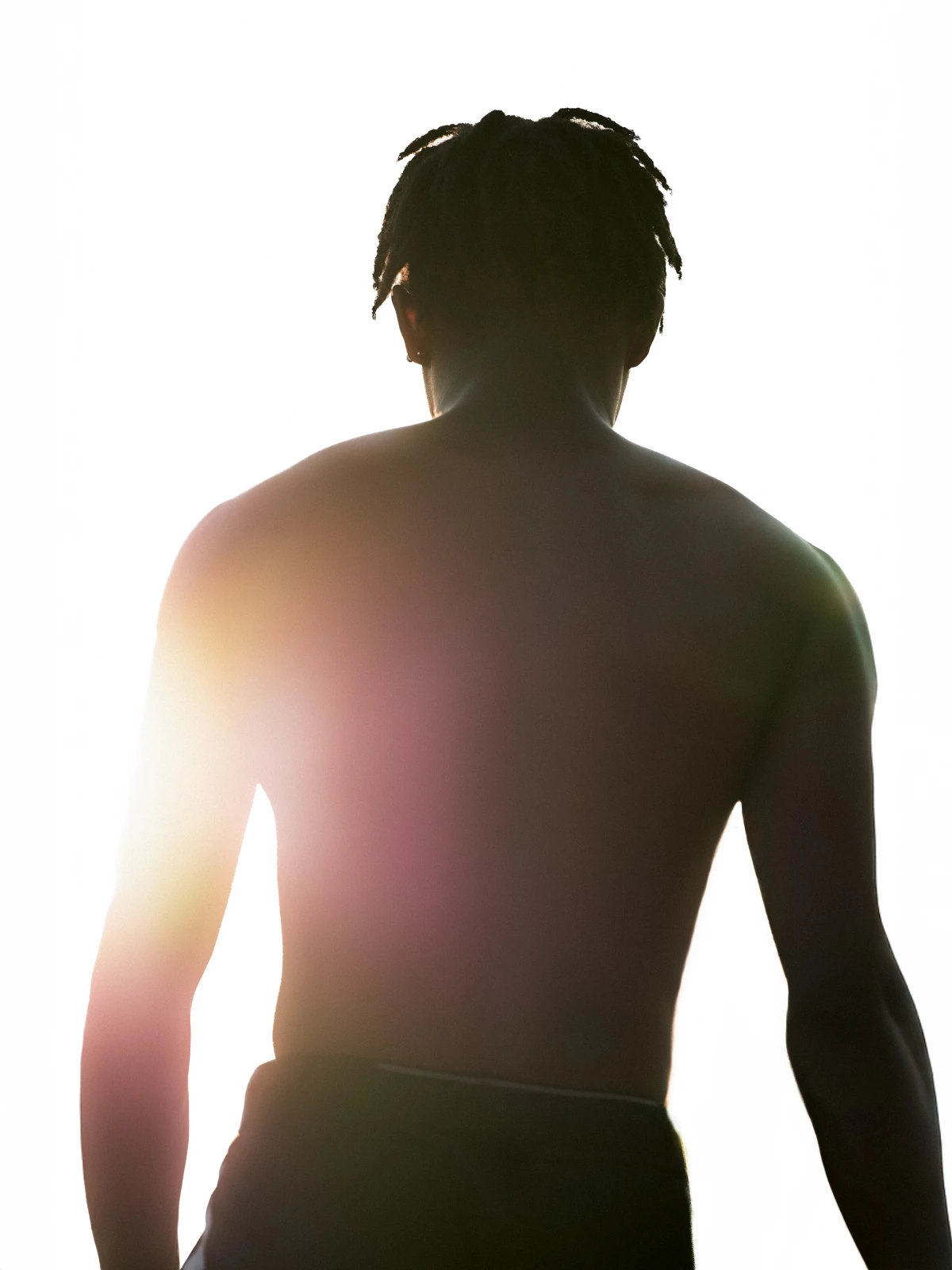 Back view of athlete against bright sun flare for Reebok sportswear campaign