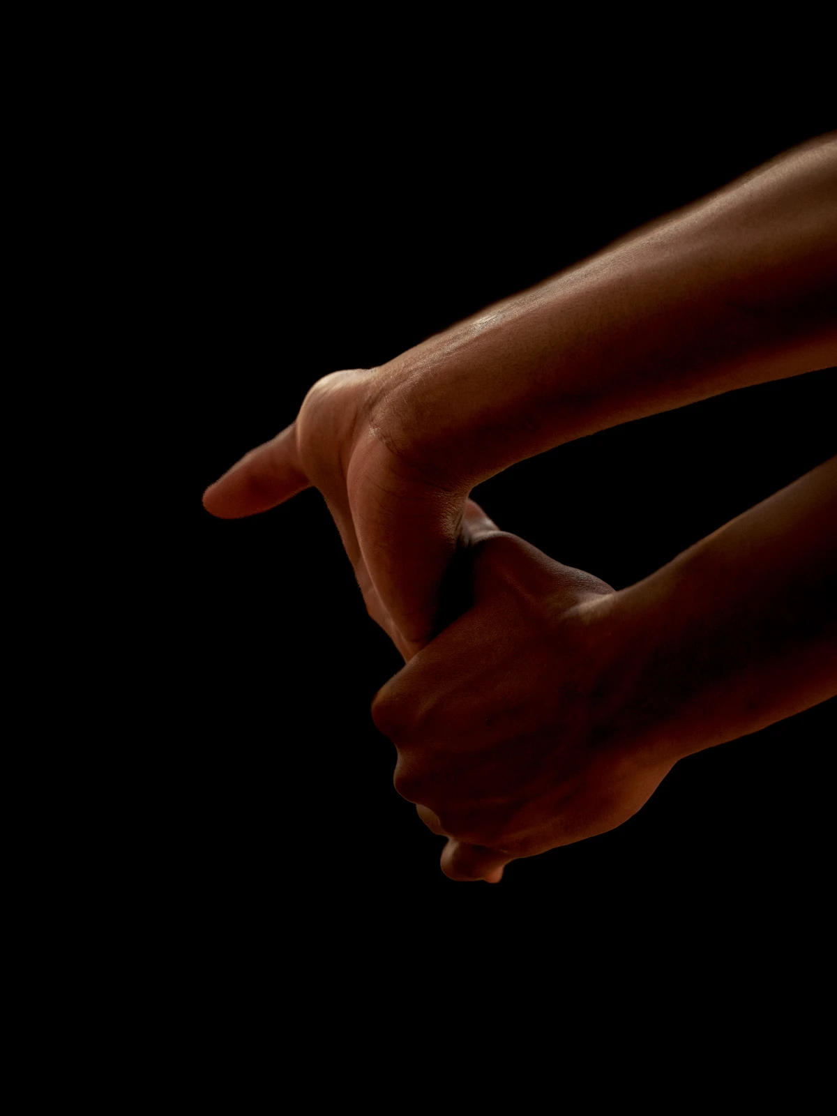 Close-up of athlete hands against black background for Spalding sports campaign