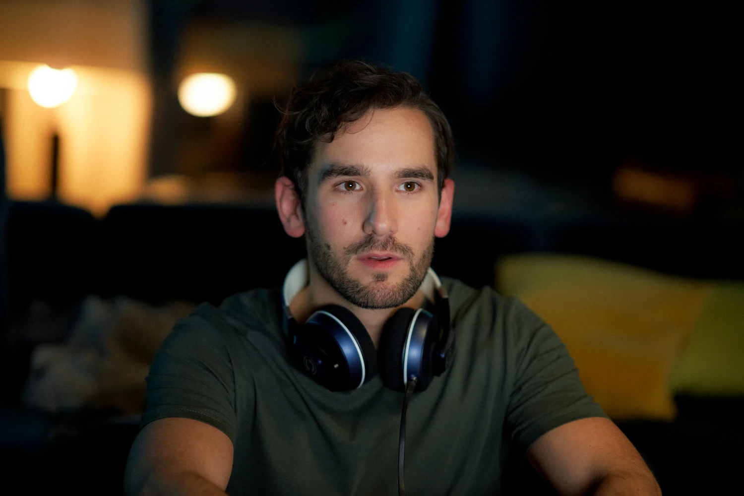 Young man with headphones in warm interior light for Fyrst lifestyle technology campaign