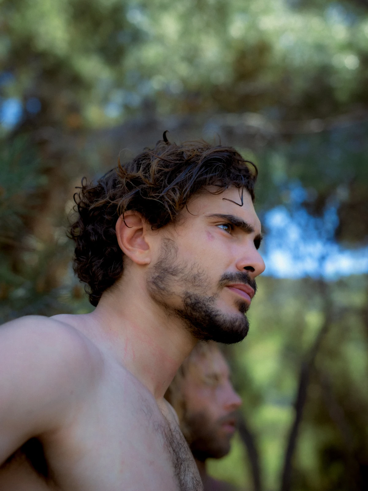 Bearded young man in sunlit forest for Becks lifestyle beer campaign